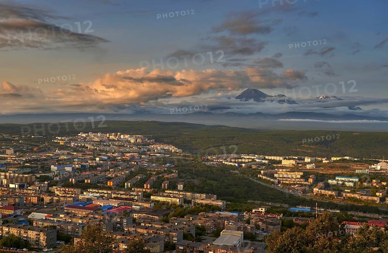 Petropavlovsk-Kamchatsky city at sunset and cone of Koryak volcano. Kamchatka Peninsula, Russia, Europe