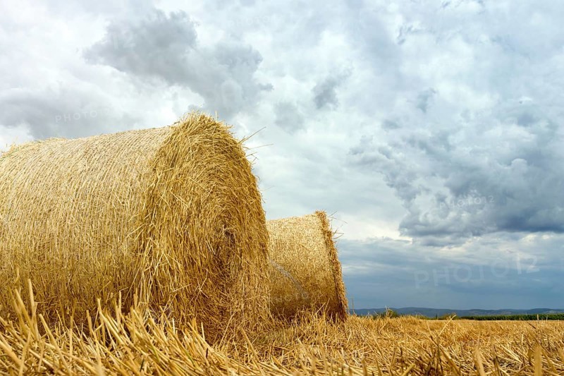 Straw bales on farmland Storm clouds