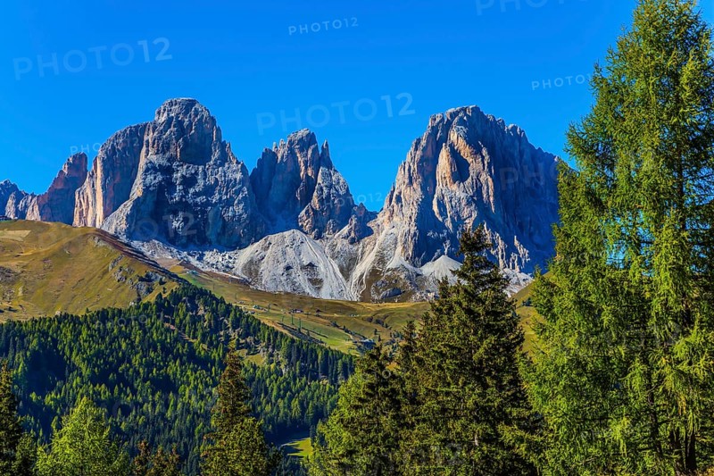 The most picturesque route in the Italian Dolomites, the Southern Limestone Alps. The coniferous forests at the foot of limestone and dolomite rocks. The concept of active and car tourism
