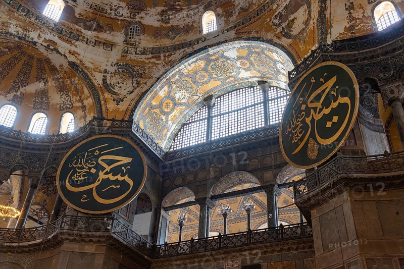 A picture of two of the calligraphic roundels inside the Hagia Sophia, in Istanbul