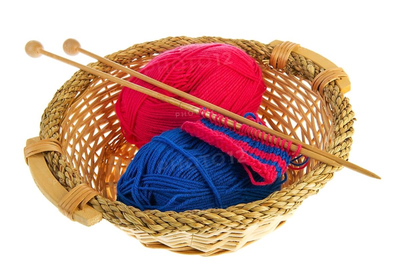Knitting in blue and red with wooden needles
