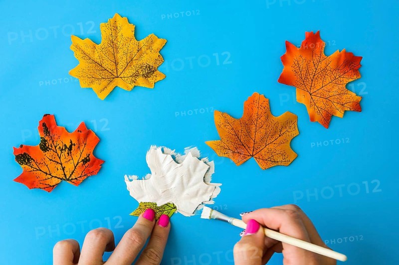 Maple leaf with painted face as decoration for autumn Halloween holiday celebration. Halloween party in October. Holiday Diy preparation. Step by Step Mysterious Jack head lantern