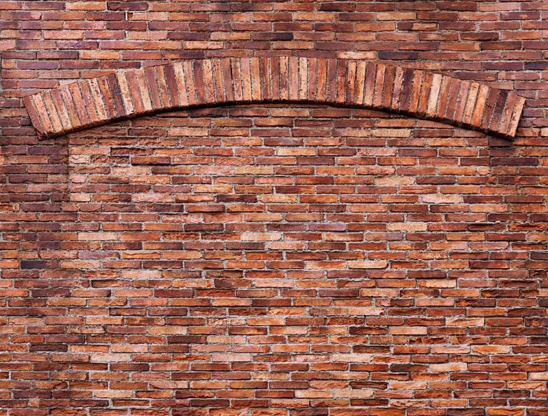 Texture of old red brick wall with an arch, grungy background