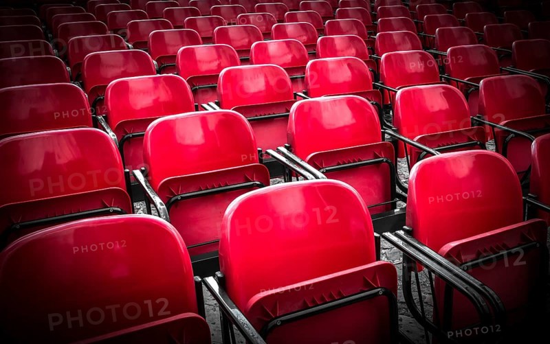 Empty plastic red chairs In outdoor theater in sunny day. Close Up