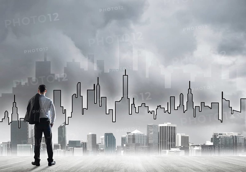 Motivation and inspiration concept with modern cityscape and businessman observing it