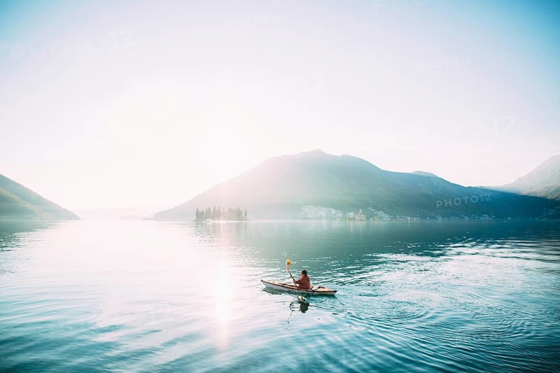 Kayaks in the lake. Tourists kayaking on the Bay of Kotor, near the town of Perast in Montenegro. Aerial Photo drone