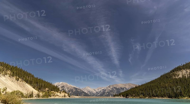 The turquoise waters of Whitemans Pond at an elevation of 1876m and surrounded by the east end of Mount Rundle, Ha Ling Peak and Mount Lawrence just outside of Canmore, Alberta, Canada, North America