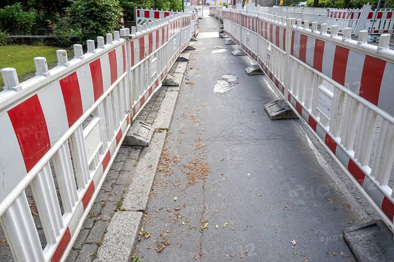Construction site barrier of a road with a sidewalk