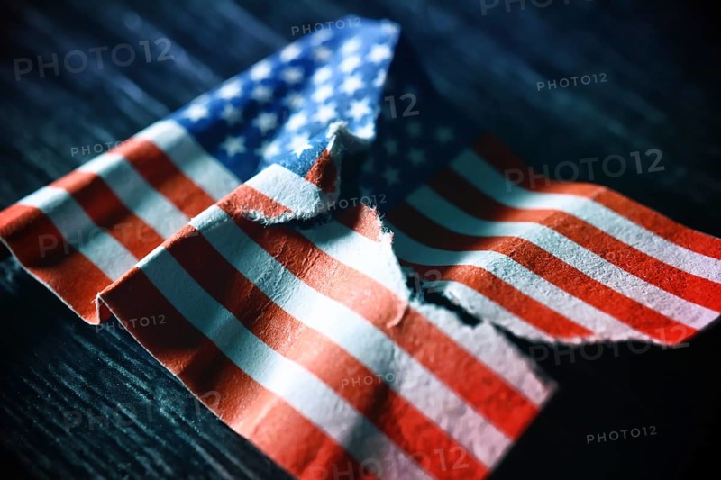 Torn US flag, symbolic photo for a divided society in the USA