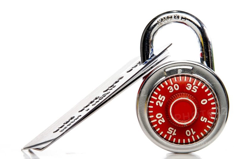A set of credit cards secured with a padlock