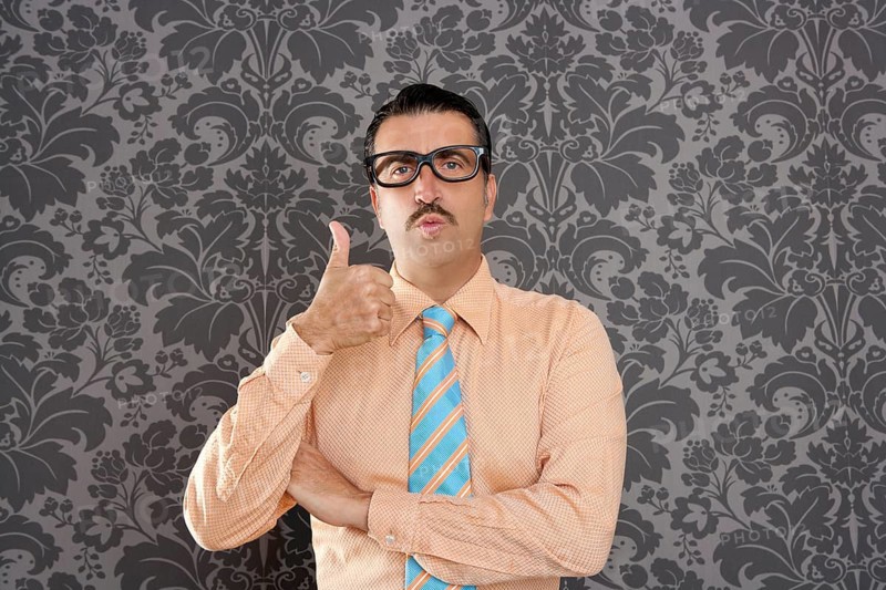 Nerd businessman gesturing ok positive with hand over retro wallpaper