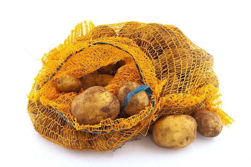 Plastic bag full potatoes isolated over white background