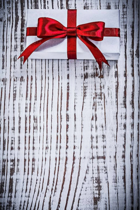 Copyspace of packed giftbox on vintage wood board holidays concept