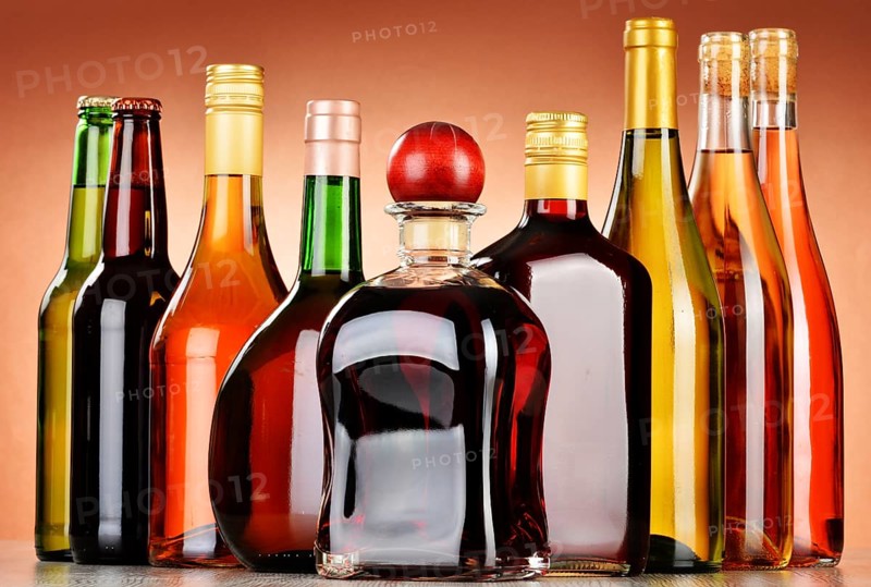Bottles of assorted alcoholic beverages including beer and wine