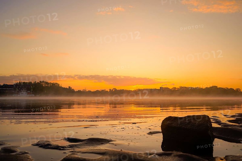 Sunrise over the Weser with stones and fog in the foreground, Julius Plate ferry pier 27804 Berne