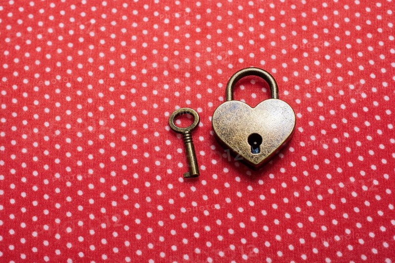 Heart shaped lock and key on an abstract background