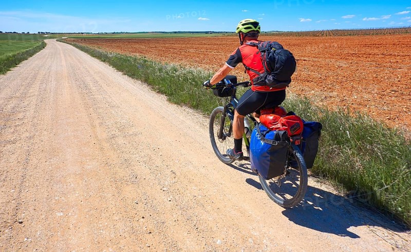 Biker pilgrim by Camino de Santiago in bicycle at Saint James Way of Levante
