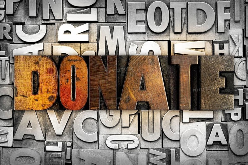 The word DONATE written in vintage letterpress type