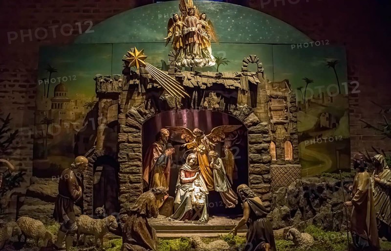 Traditional Christmas nativity scene with beautiful figures made out of wood. The birth of Jesus Christ in the manger surrounded by Joseph, Mary and shepherd.