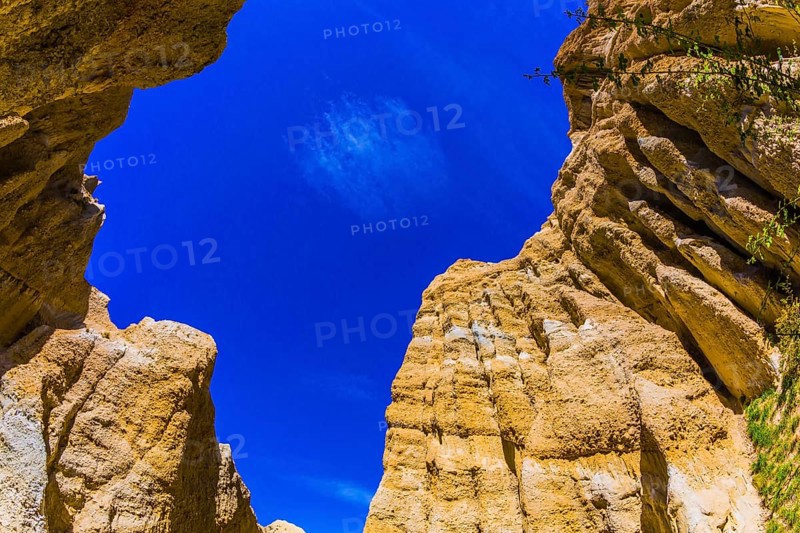 Scenic Clay Cliffs. Bright blue sky above the tops of picturesque rocks. Travel to New Zealand. The concept of active, eco and photo tourism