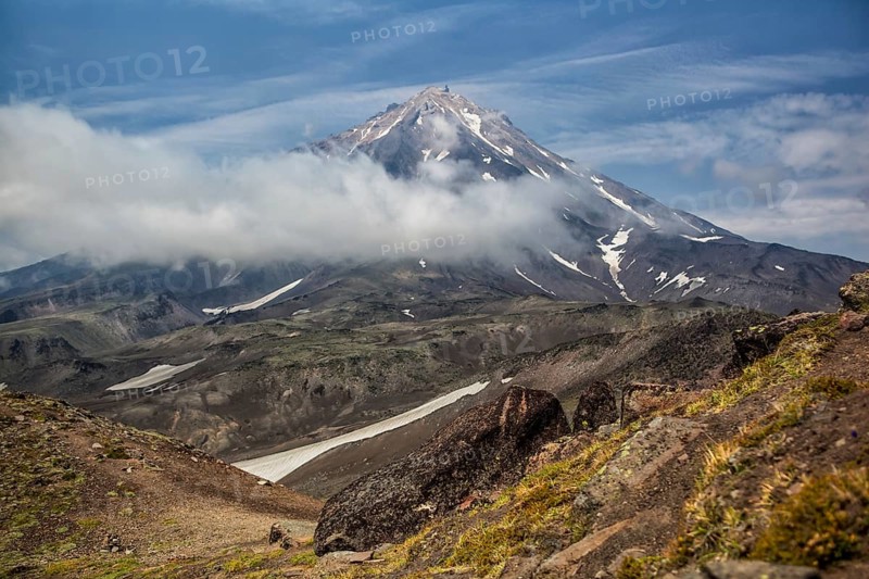 Mountains and volcanoes. Beautiful landscape of Kamchatka Peninsula: summer panoramic view of Mountain Range Vachkazhets, mountain lake and clouds in blue sky on sunny day. Eurasia, Russian Far East, Kamchatka Region