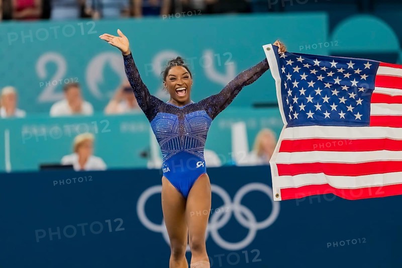 Simone Biles (USA) of the United States celebrates with the fans after winning the Artistic Gymnastics Women's All-Around Final at the Bercy Arena during the 2024 Paris Summer Olympics in Paris, France. (persons) of (persons)#4, competes in the Women's All-Around Finals at the Bercy Arena during the 2024 Paris Summer Olympics in Paris, France, Europe