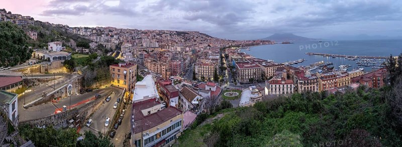 Panorama of Naples with the Gulf and the famous Vesuvius in the clouds after sunset
