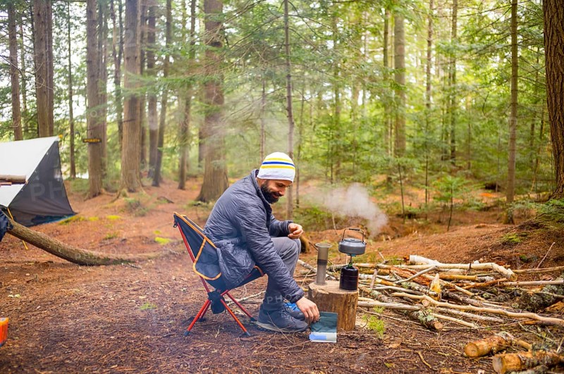 Man in a Camping Sight of Natural Reserve in Little Tupper Lake Park, New York State - US