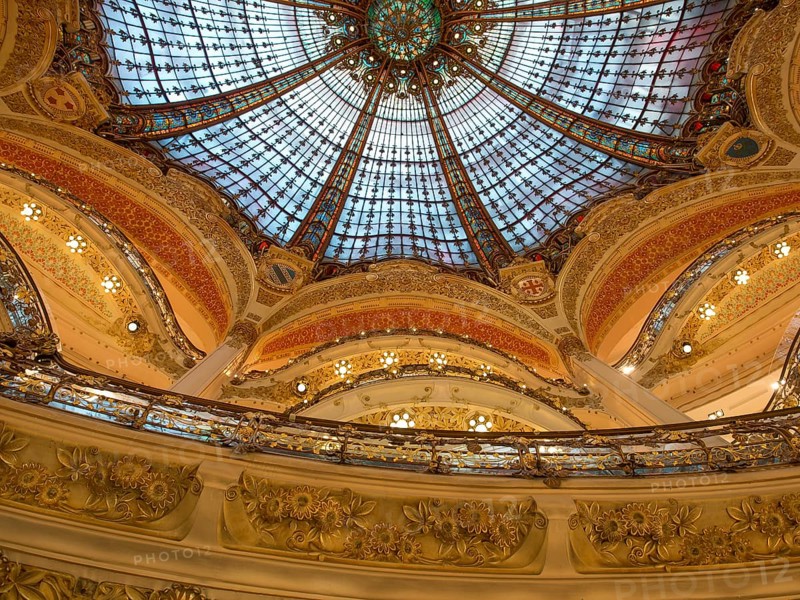 Magnificently decorated dome with colourful stained glass windows that shine in golden light, rich in architectural details, paris, france
