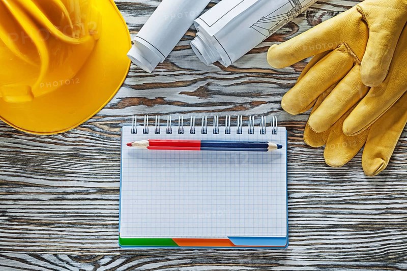 Safety gloves building helmet blueprints notepad pencil