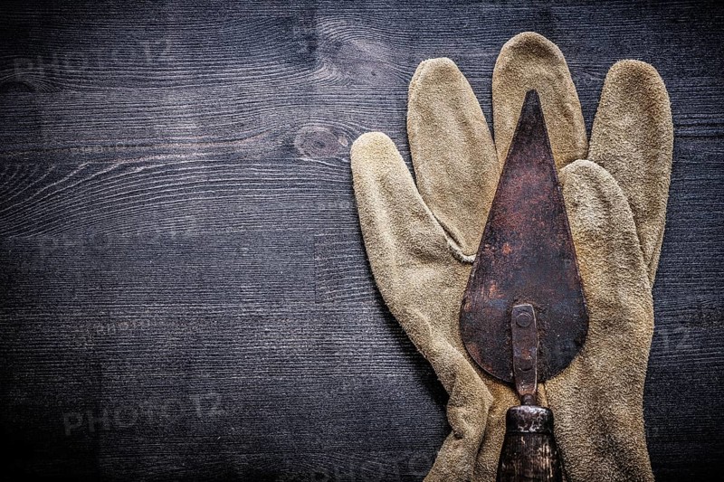 Horizontal view vintage tools putty spattle on glove