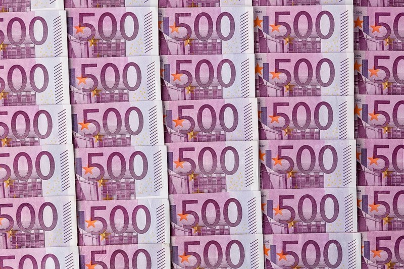 Many five hundred euro banknotes lying next to each other. Symbolic photo for wealth and investment Austria