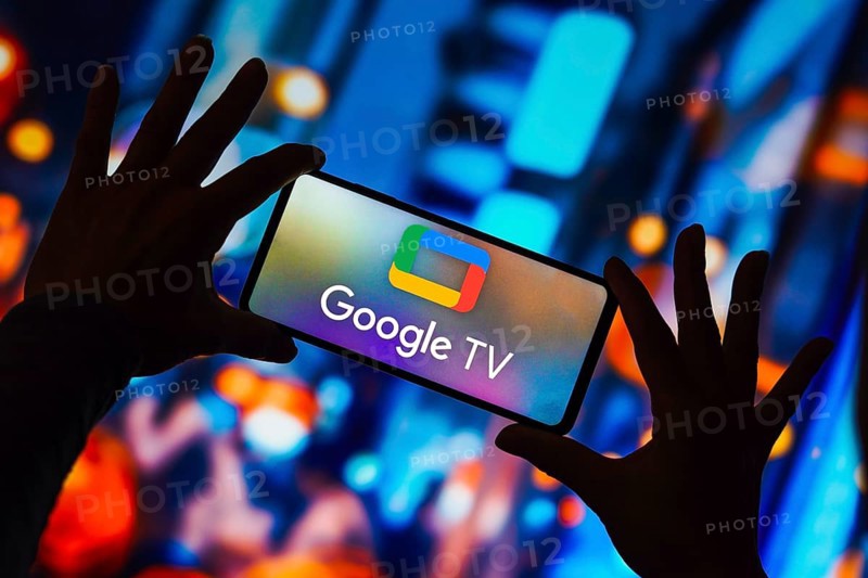 In this photo illustration, the Google TV logo is displayed on a smartphone screen