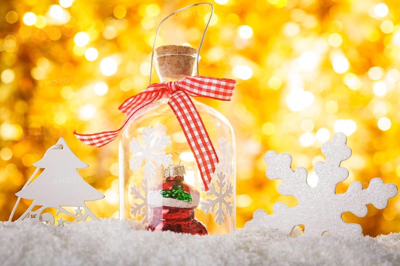 Christmas decor on the snow with gold bokeh background