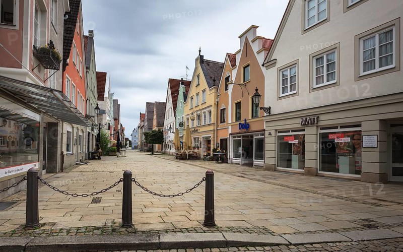 An empty shopping street with historic buildings and shop fronts under a cloudy sky, pedestrian zone Mindelheim, Bavaria, Germany, Europe
