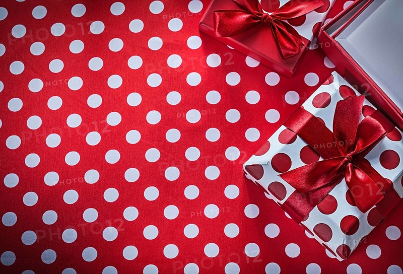 Present boxes on polka-dot red print background celebrations concept
