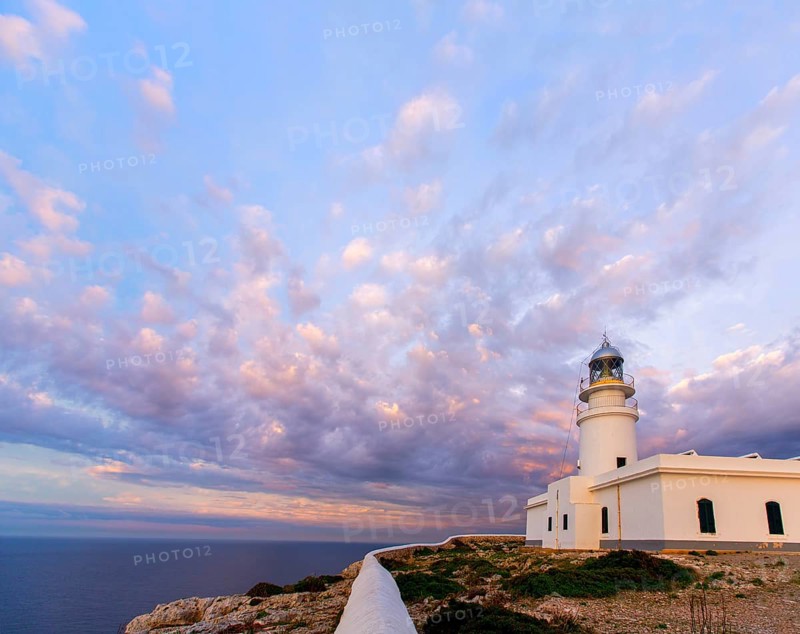Menorca sunset in Faro Far de Caballeria Lighthouse at Balearic Islands es Mercadal