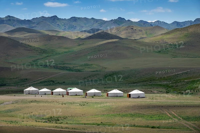 Traditional yurts between montains at sunset, Mongolia, Asia