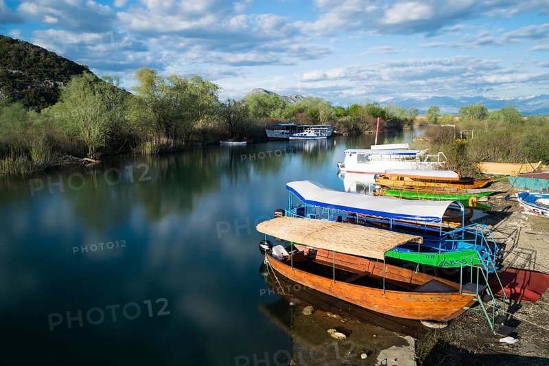 Colorful boats and sunny weather at Virpazar Harbor, Skadar Lake, Montenegro, Europe