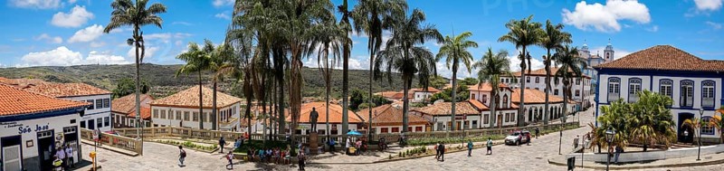 Panorama of traditional houses and palm tree lined street in historic center of Diamantina on a sunny day, Minas Gerais, Brazil, South America
