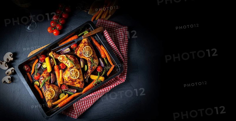 Grilled chicken legs with various vegetables and herbs