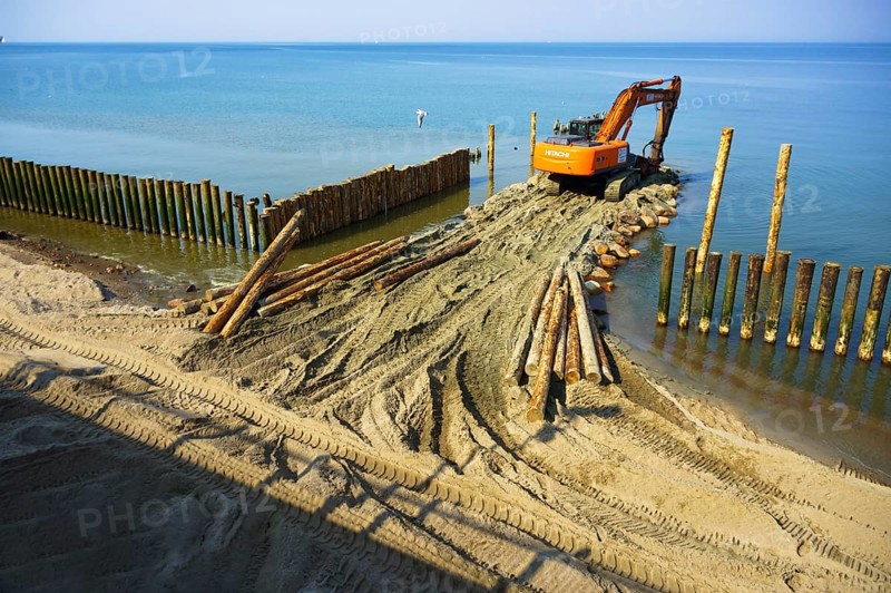 Construction equipment on the shore, the construction of breakwaters, coastal protection measures, Baltic sea, Russia, Kaliningrad region, March 28, 2020, Europe