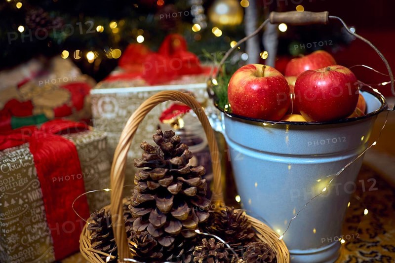 Christmas composition with red apples, gifts and gingerbread. Christmas in retro style. Vintage decoration. Cozy interior.