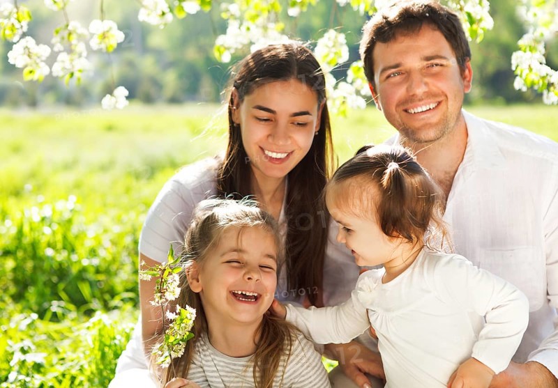 Happy young family with two children outdoors. Spring day