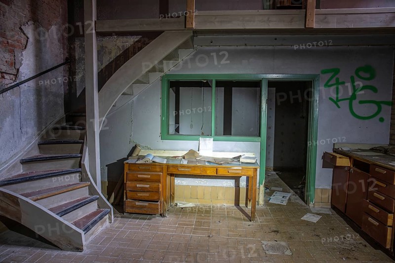 Old abandoned paper factory. Historic and typical factory building as a lost place. Destruction and decay are damaging the substance. Original machines and objects can be found here in Sweden