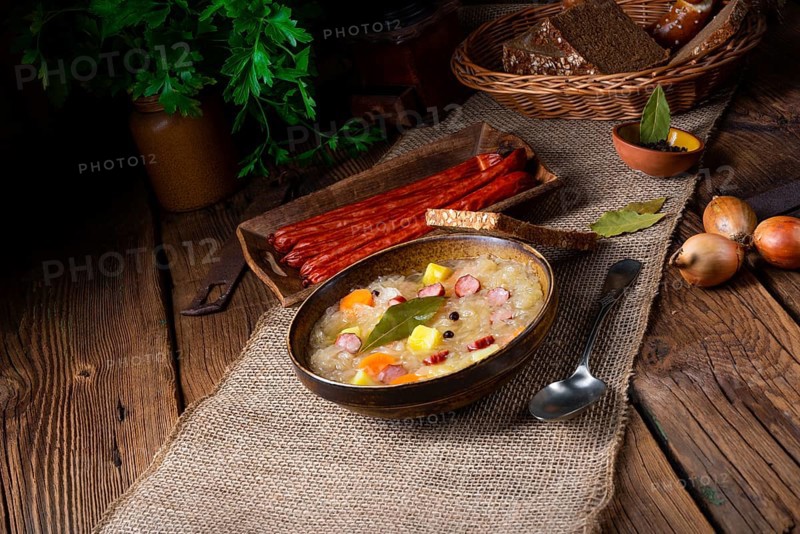 Rustic sauerkraut soup with bacon and sausage