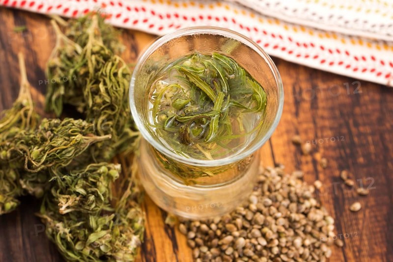 Cannabis herbal tea on wooden background
