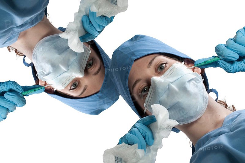 A beautiful young woman surgeon performing surgery