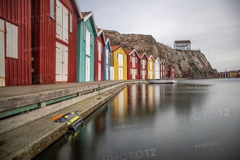 Small colourful houses by the sea. Typical houses in Sweden for the coastal landscape. Crab fishing and storage in a narrow harbour. Smögen, Smögenbryggan, Sweden, Europe