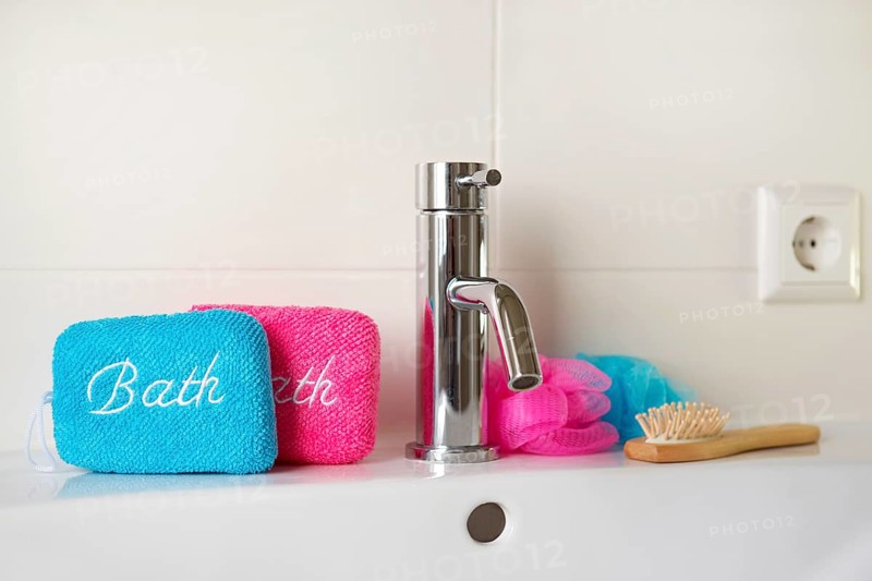 Bathroom with blue and pink sponges on sink